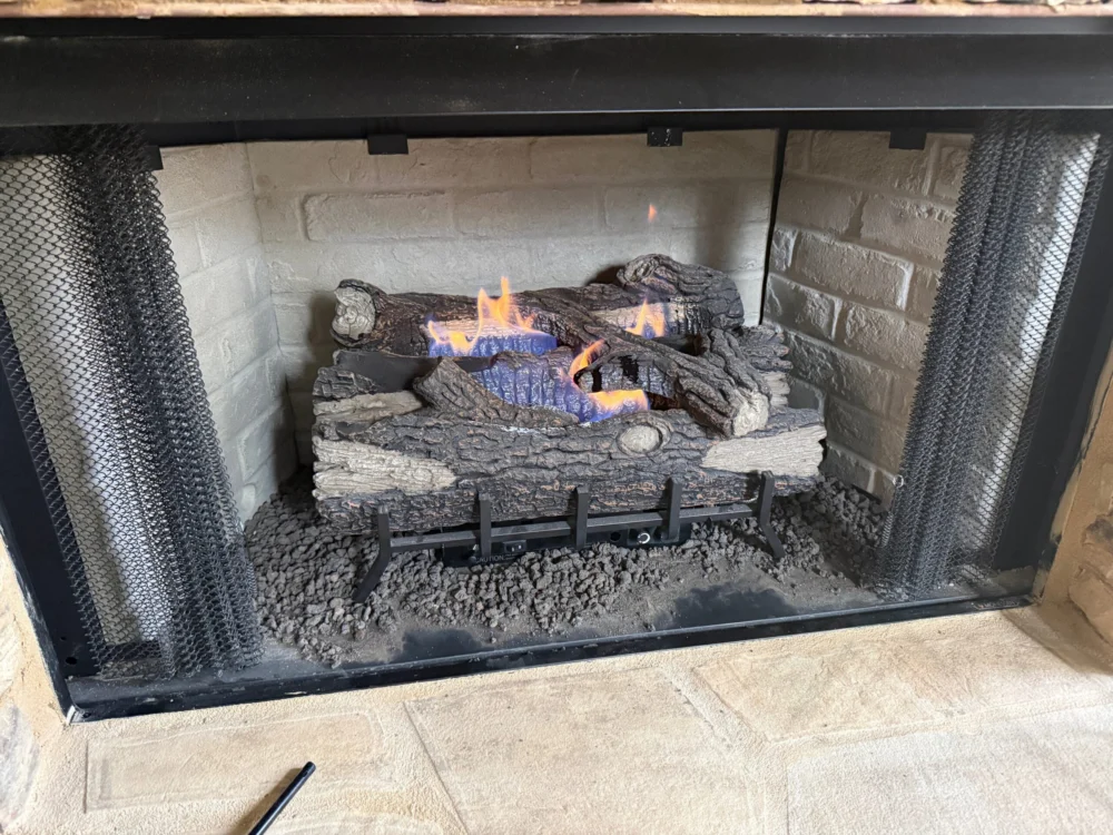 Gas log fireplace with glowing flames