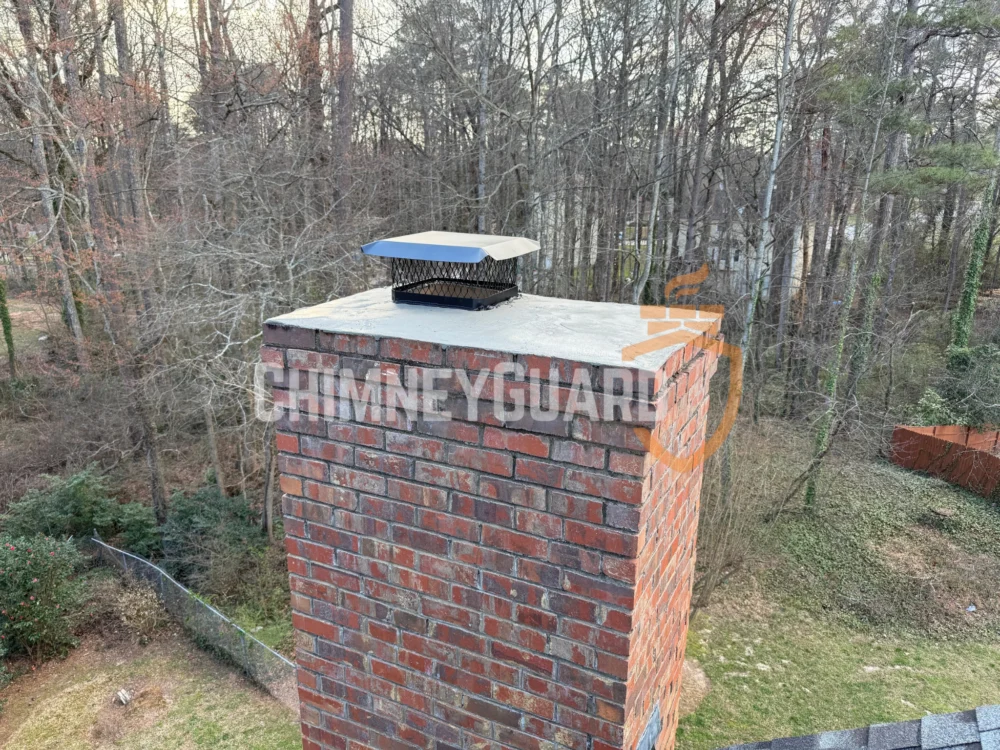 Finished brick chimney with a metal chase cover